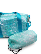 Shiny turquoise duffel bag with matching drawstring bag.
