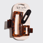 Set of three tortoiseshell and black hair clips in packaging with 'kit-sch' branding.